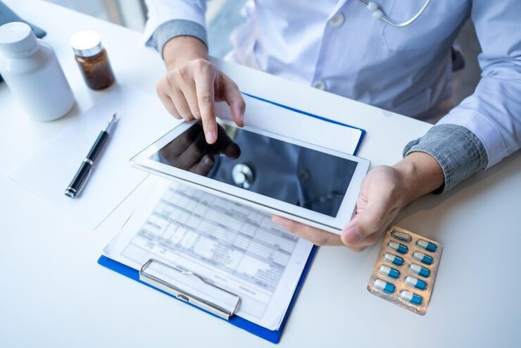 high-angle-view-doctor-using-digital-tablet-table_1048944-5798889